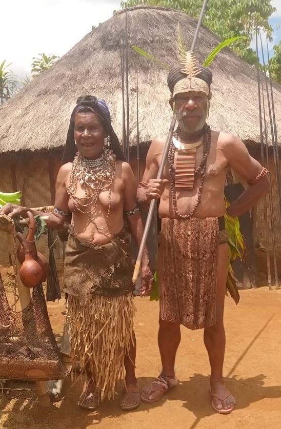 Old PNG Couple in Traditional Attire and Round House2 Old PNG Couple in Traditional Attire and Round House2