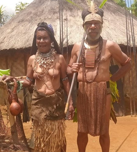 Old PNG Couple in Traditional Attire and Round House3 Old PNG Couple in Traditional Attire and Round House3